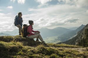 Austria, Tyrol, Tannheimer Tal, young couple resting on hiking tour